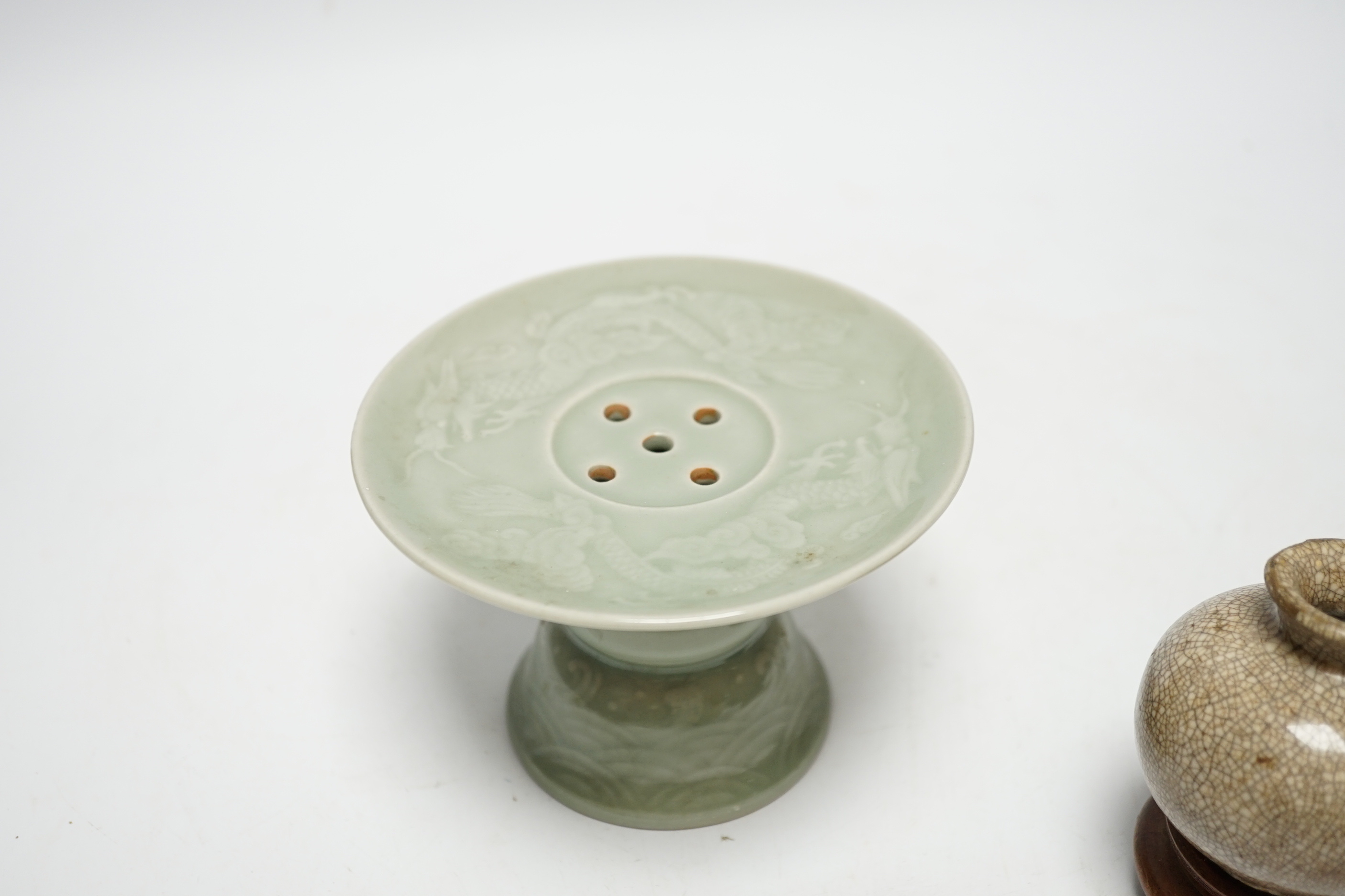 A Chinese celadon glazed 'dragon' puzzle cup and stand, early 20th century and a Chinese crackle glaze vase, 19th century, cup 7.5cm